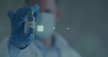 Healthcare professional wearing mask and gloves presenting COVID-19 vial in lab, digital overlays....