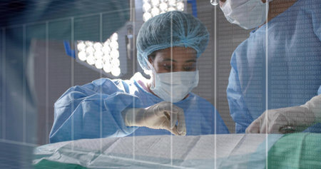 Mid adult surgeon in blue gown making incision in operating room, with scalpel and forceps. Medical...