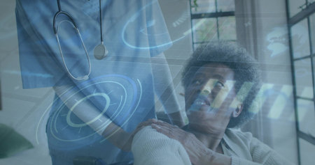 Assisting nurse in scrubs with stethoscope supporting wheelchair user in living room, data overlay. Healthcare, caregiving, eldercare, telemedicine, homehealth, digital interface, wellnessの写真素材