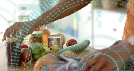 Reaching forearms wearing orange shirt on wooden countertop, handling fresh produce and pantry jars. Organic, nourishment, rustic, homemaking, wellness, culinary, domesticの写真素材