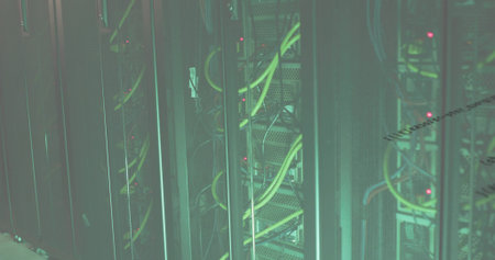 Blinking rackmount servers showing LED lights in data center, with yellow and blue Ethernet cables....