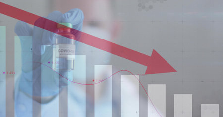 Gloved researcher wearing scrubs holding small COVID-19 vial in lab, with red downward arrow chart....