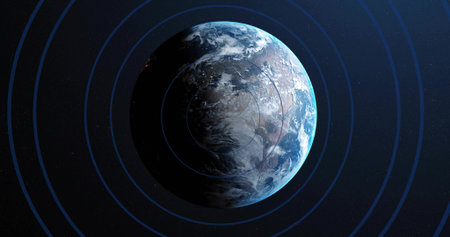 Rotating planet Earth partially illuminated by sunlight in outer space, with concentric blue rings....