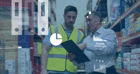 Two men wearing safety vest and shirt reviewing clipboard in warehouse aisle with data overlays....