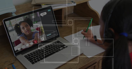 Showing laptop at home desk with peer speaking on headset, peer writing notebook using green pencil. Collaboration, remote learning, digital communication, student teamwork, educational tools, creative expression, vibrant styleの写真素材