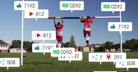 Training soccer players gripping pull-up bar on suburban field, pulling up with media icons....