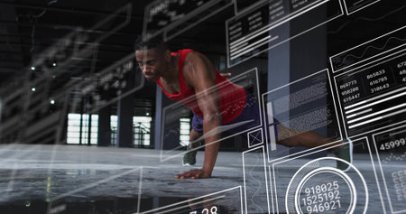 Performing push-ups man wearing red tank top and shorts in warehouse, with AR charts, copy space. Fitness, technology, innovation, industrial, urban, strength, dynamicの写真素材