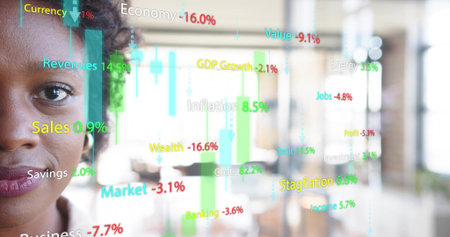 Studying businesswoman reviewing colorful financial overlay in open-plan office, copy space. Technology, analytics, data, finance, corporate, professional, modernの写真素材