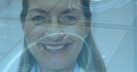 Smiling woman wearing blue shirt interacting with interface in lab, with circular targets, readouts....