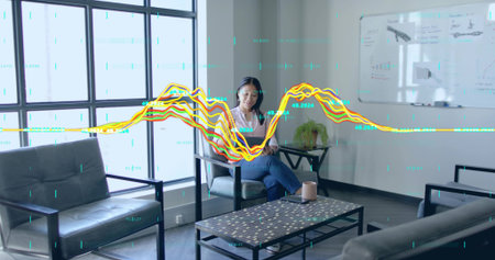 Working Asian woman typing on laptop in meeting room, showing coffee table, whiteboard, data lines....