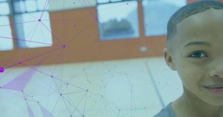 Standing boy wearing gray T-shirt scanning basketball court through network overlay, copy space. Athletic, technology, youth, sports, education, modern, digitalの写真素材