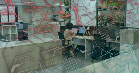 Working woman using keyboard and mouse at modern office desk, with laptop dual monitors and plants. Contemporary, collaborative, innovative, workspace, creative, productivity, vibrantの写真素材