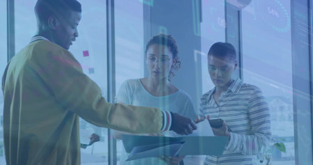 Colleagues in business attire analyzing data in glass office, with sticky notes, documents, tablet. Collaboration, teamwork, modern workspace, data analysis, digital interfaceの写真素材