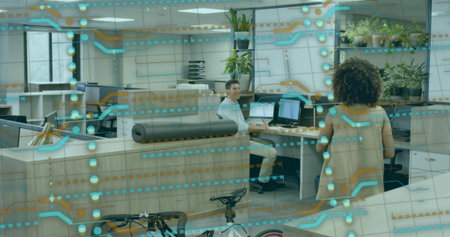 Reviewing data, man in business attire sitting at desk in open office, with dual monitor overlay....