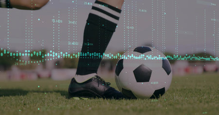 Showing player's legs wearing socks and cleats beside soccer ball on grass pitch, with data overlay. Athletic, performance, analytics, sportswear, competition, fitness, biomechanicsの写真素材