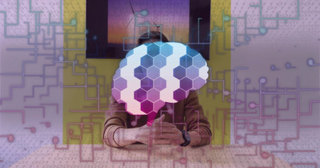 Presenting Asian host sitting at studio table, showing brain graphic with smartwatch and display. Technology, innovation, robotics, artificial intelligence, digital, futuristic, professionalの写真素材