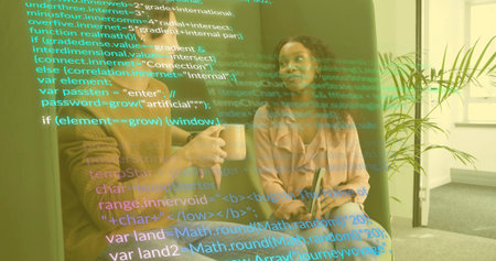 Two software professionals discussing code overlay on sofa in office lounge, with mug and tablet. Technology, collaboration, innovation, modern, workspace, digital, teamworkの写真素材