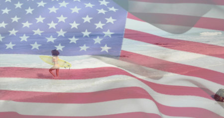 Walking surfer wearing swimwear, carrying yellow surfboard on shallow shore, with US flag overlay. Coastal, patriotism, adventure, vibrant, leisure, outdoor, empowermentの写真素材