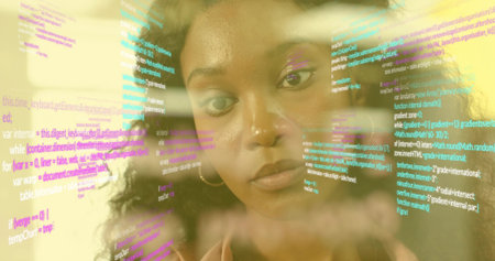 Analyzing software developer reviewing transparent display in tech office, with multicolored code. Technology, innovation, futurism, digital, creative, programming, modernの写真素材