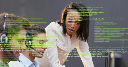 Leaning Black woman guiding seated colleague at office desk with headphones, floating code overlay....