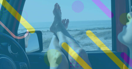 Gazing traveler wearing shorts, propping bare legs on dashboard in parked car with sandy shore view. Leisure, relaxation, adventure, scenic, sunny, travel, minimalistの写真素材