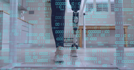 Showing woman wearing slim-fit trousers using prosthetic limb at home office, with binary overlay. Futuristic, resilient, innovation, technology, accessibility, modern, empowermentの写真素材