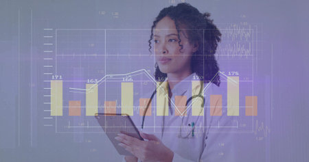 Holding tablet doctor gazing left inside studio, with stethoscope, bar charts, line graphs overlay. Medical, healthcare, technology, data, digital, innovation, professionalの写真素材
