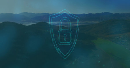Transparent dotted-line shield graphic hovering over misty mountain valley, with padlock icon. Security, cybersecurity, protection, digital, technology, data, innovationの写真素材