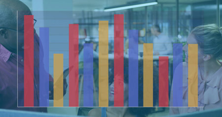 Reviewing data team consulting monitor in open office, with keyboard, bar chart overlay. Collaboration, teamwork, analytics, modernoffice, professionaldevelopment, dataanalysis, creativeworkspaceの写真素材