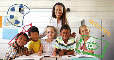 Smiling teacher guiding five students at classroom table, with open books and paint palette doodles....