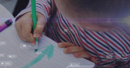 Drawing child's hands marking arrow on lined paper at desk, with green marker and digital overlays....