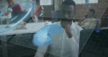 Studying data analyst in white shirt examining holographic grid and charts at office desk, teamwork....
