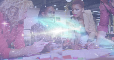 Collaborating business professionals discussing charts and markers at office table. Corporate,...