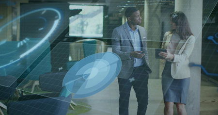 Coworkers analyzing holographic charts holding smartphone and tablet wearing suits in office lounge....