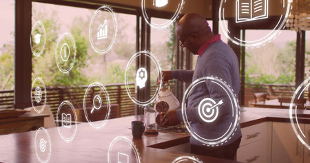 Man in sweater pouring water from kettle into coffeemaker in kitchen, with icons, copy space....