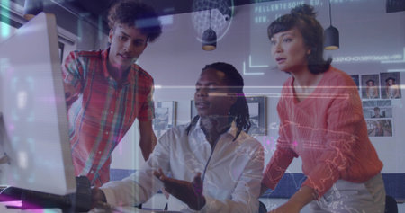 Collaborating coworkers analyzing holographic data overlays on desktop monitor in office. Futuristic, teamwork, innovation, digital, modern, interaction, technologyの写真素材