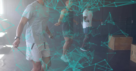 Skipping participant wearing grey t-shirt and shorts inside gym, with skipping ropes, copy space. Fitness, exercise, training, strength, athletic, cardio, motivationの写真素材