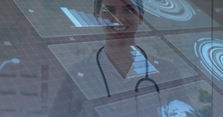 Standing female physician analyzing floating data on digital display in clinic with stethoscope. Medical, healthcare, technology, innovation, analysis, futurism, clinicalの写真素材