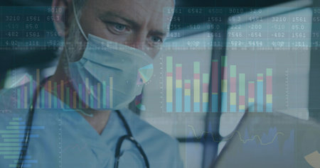 Monitoring doctor in clinic wearing scrubs and stethoscope viewing laptop data graphs, copy space....