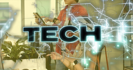 Standing tech pro in red shirt tapping tablet using overlay at office desk, with smartwatches....
