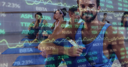 Twisting man on yoga mat in studio with mirror reflection, financial charts overlay, copy space....