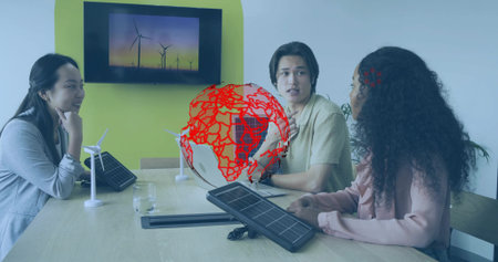 Reviewing renewable energy models, team wearing suits collaborating in boardroom with globe graphic....