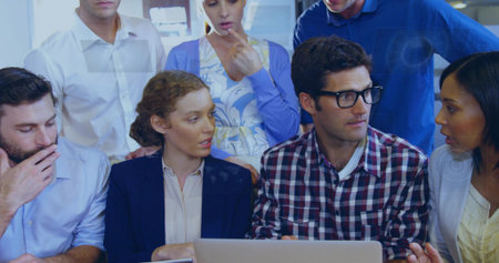 Discussing project ideas coworkers leaning toward laptop in conference room, business casual....
