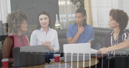 Project team wearing business casual discussing documents in lounge area, with laptops and coffee....