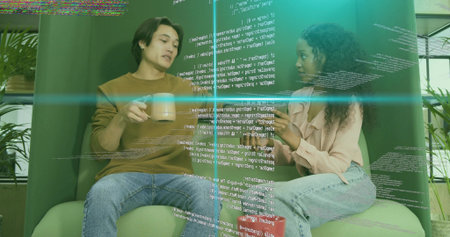 Coworkers discussing software code in break area, green chairs, coffee mugs and holographic overlay....