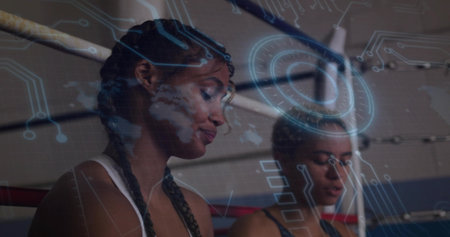 Standing training partners sweating in boxing ring, with red ropes and holographic circuit overlay....