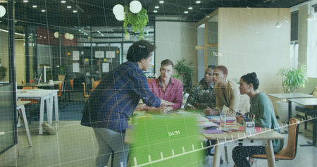 Presenting presenter leaning on green chair addressing four colleagues at office table, copy space....