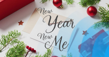 Image of new year new me text over christmas decorations. Christmas, new year and digital interface concept digitally generated image.の写真素材