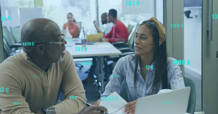 Senior man and woman reviewing documents, writing notes at conference table with digital overlays....