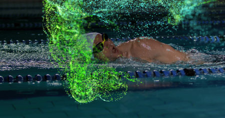 Gliding male swimmer wearing cap and goggles past lane ropes in pool, with neon digital particles. Athletic, motion, aquatic, futuristic, digital art, sport, fitnessの写真素材